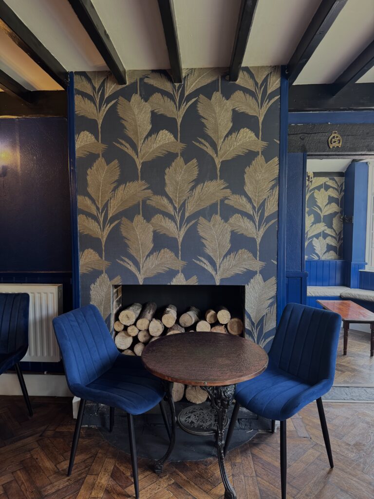 The fireplace in the pub bar of Cross Keys Upwood